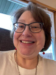 Picture of smiling White woman with shoulder-length brown hair and glasses