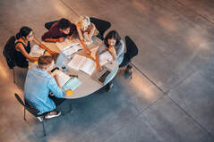 Picture of several students at a round table, taken from above a distance away